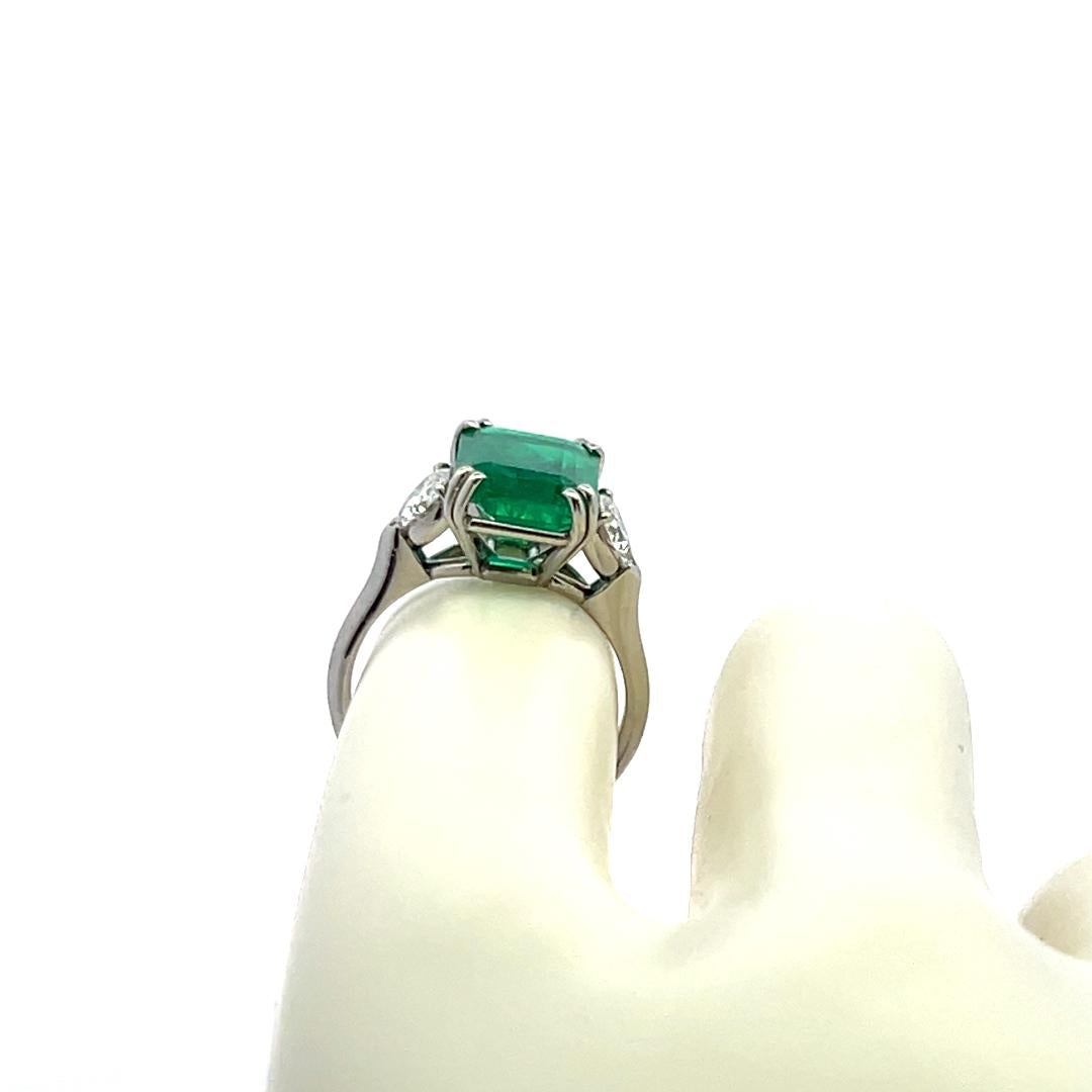 3.36 Carat Emerald 0.60 Carat Triangular Shape Diamond Platinum Engagement Ring
