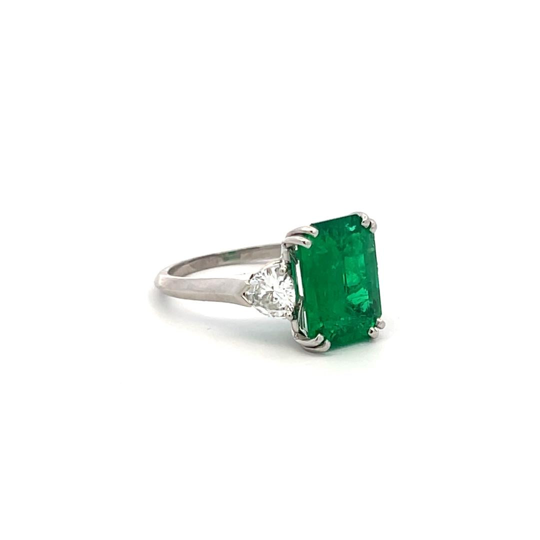 3.36 Carat Emerald 0.60 Carat Triangular Shape Diamond Platinum Engagement Ring