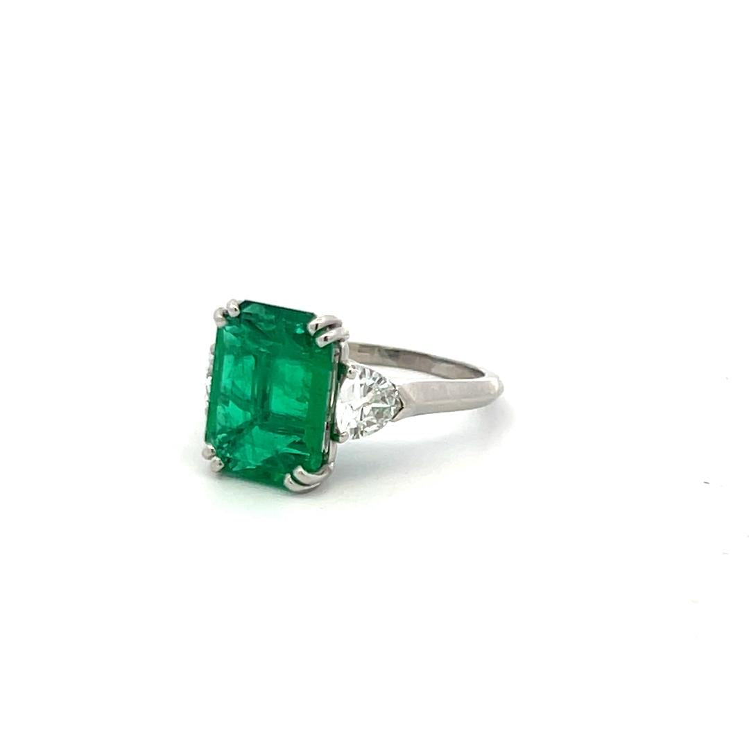 3.36 Carat Emerald 0.60 Carat Triangular Shape Diamond Platinum Engagement Ring