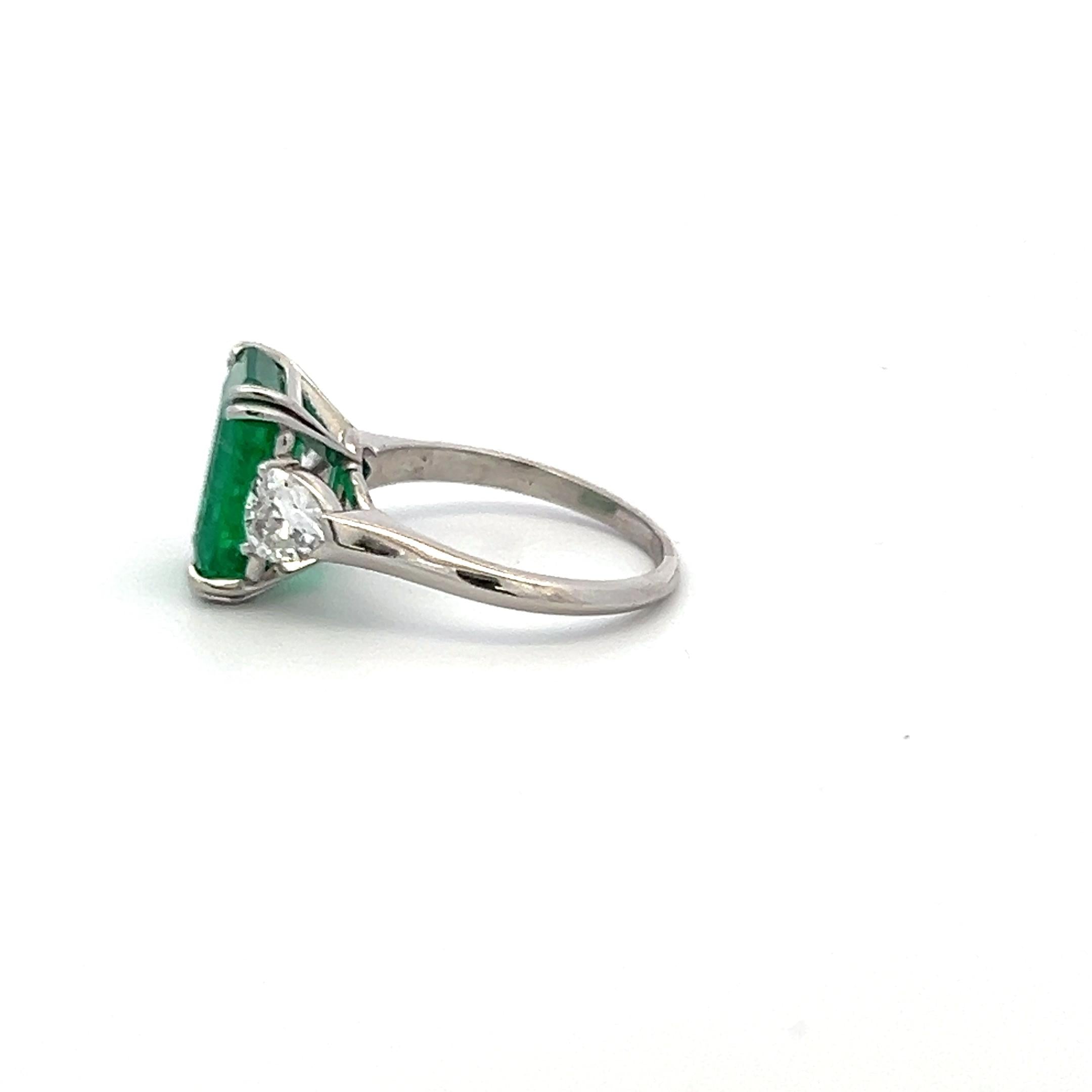 3.36 Carat Emerald 0.60 Carat Triangular Shape Diamond Platinum Engagement Ring