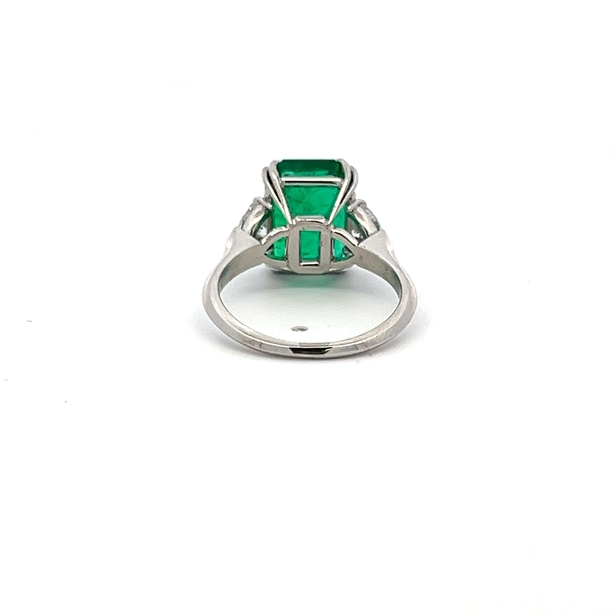3.36 Carat Emerald 0.60 Carat Triangular Shape Diamond Platinum Engagement Ring