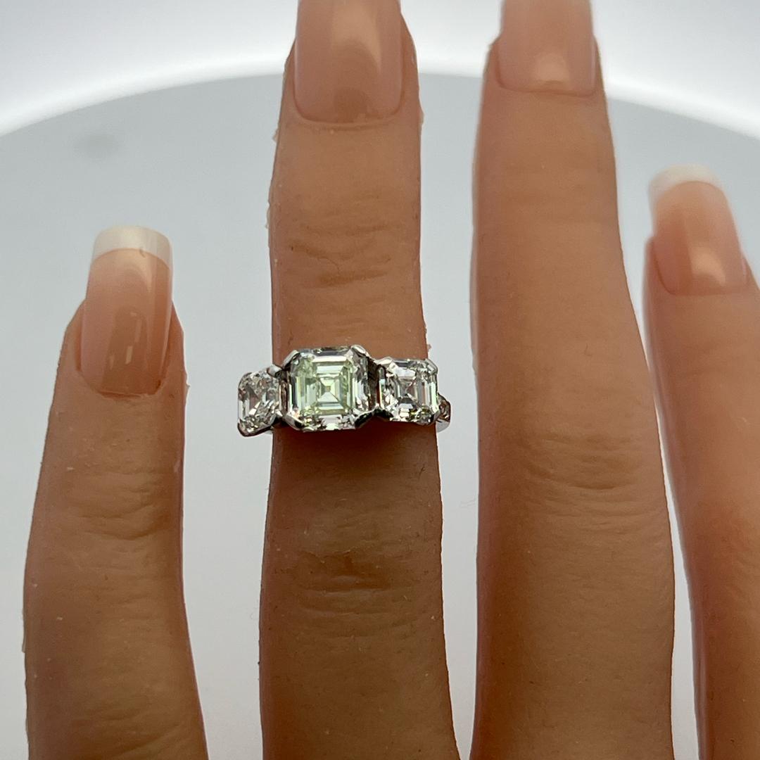Vintage White Platinum Three-Stone Ring with 3.92 Carat Asscher Cut Diamonds GIA