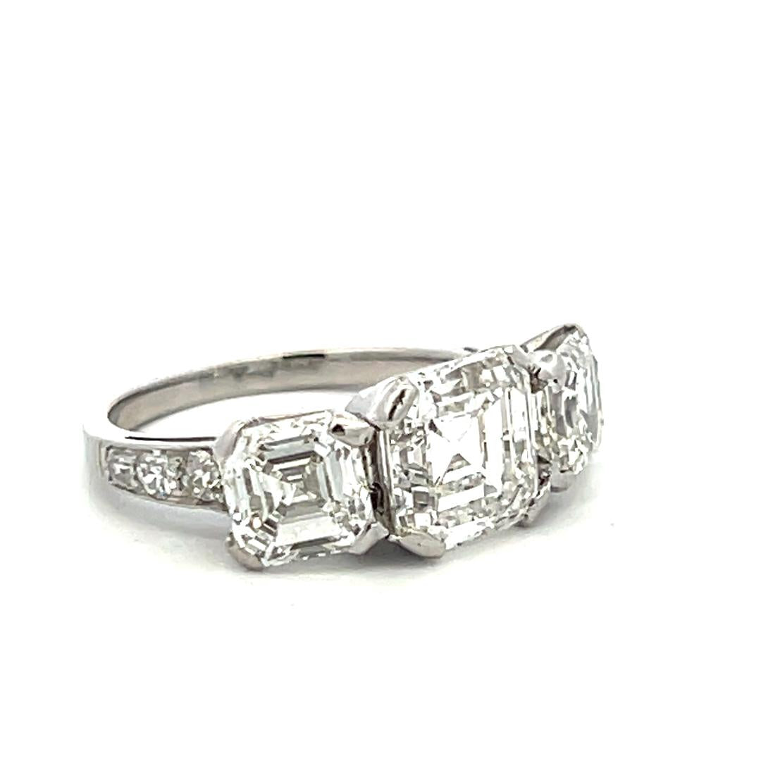 Vintage White Platinum Three-Stone Ring with 3.92 Carat Asscher Cut Diamonds GIA