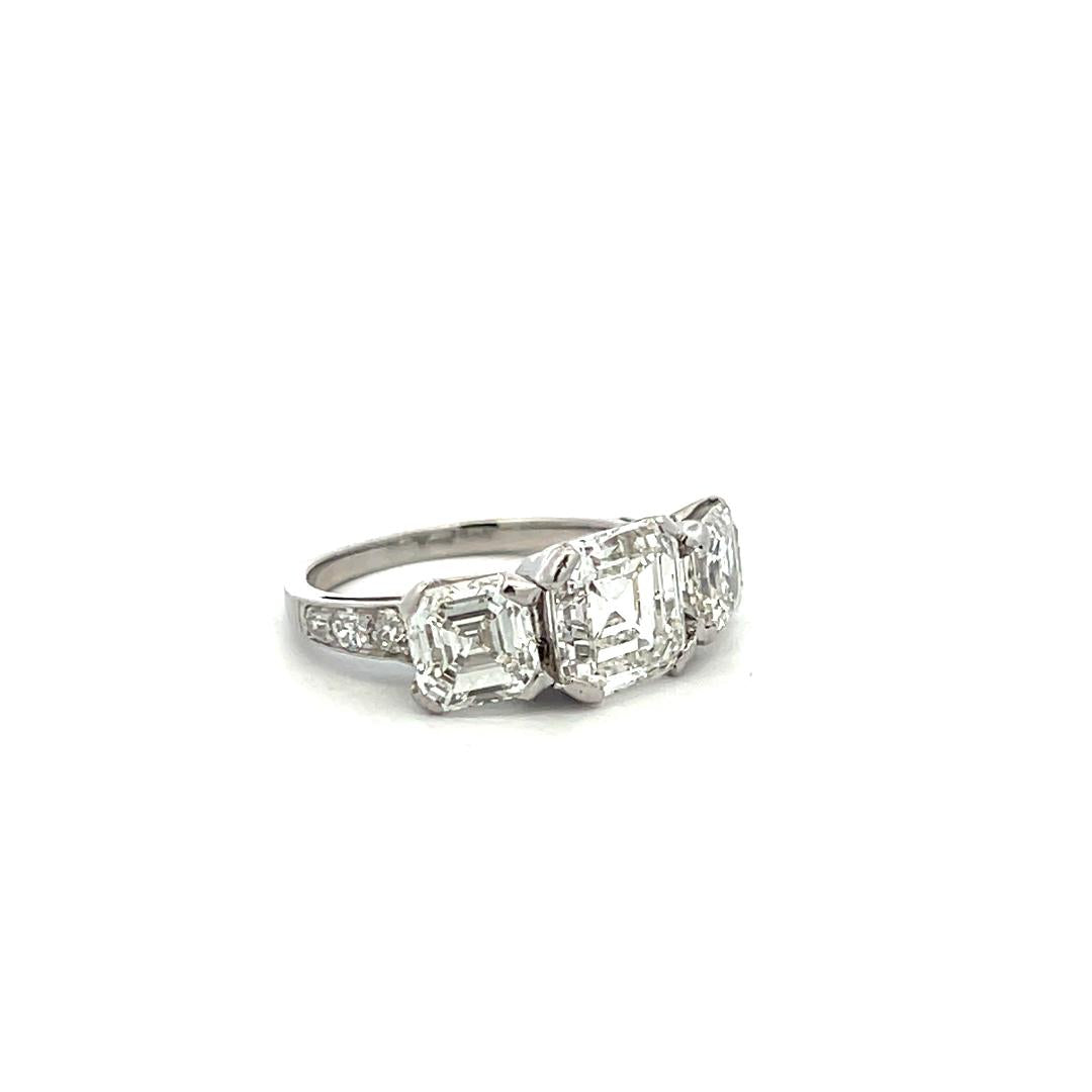 Vintage White Platinum Three-Stone Ring with 3.92 Carat Asscher Cut Diamonds GIA