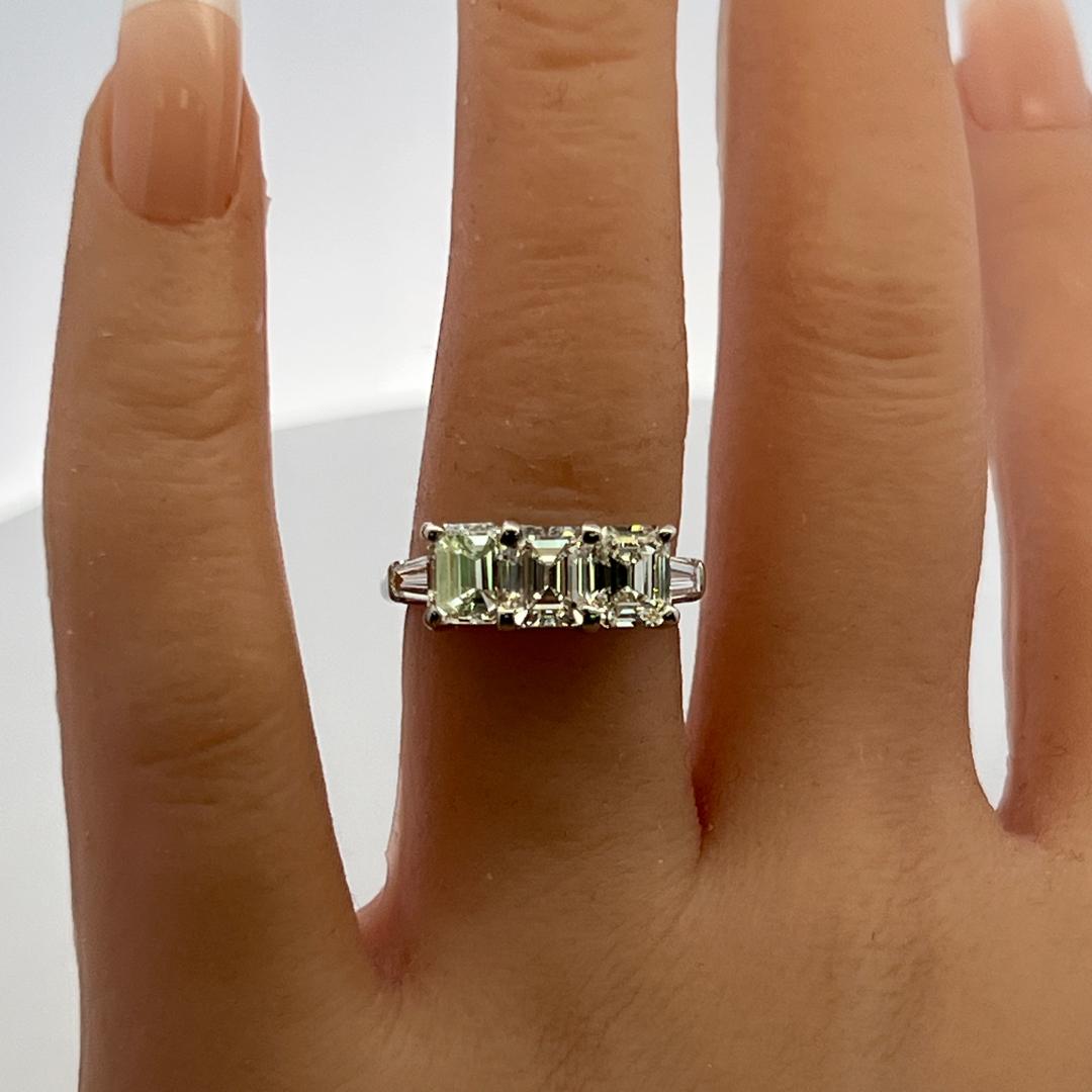 Vintage White Platinum Three-Stone Ring with 2.91 Carat Emerald Cut Diamonds GIA