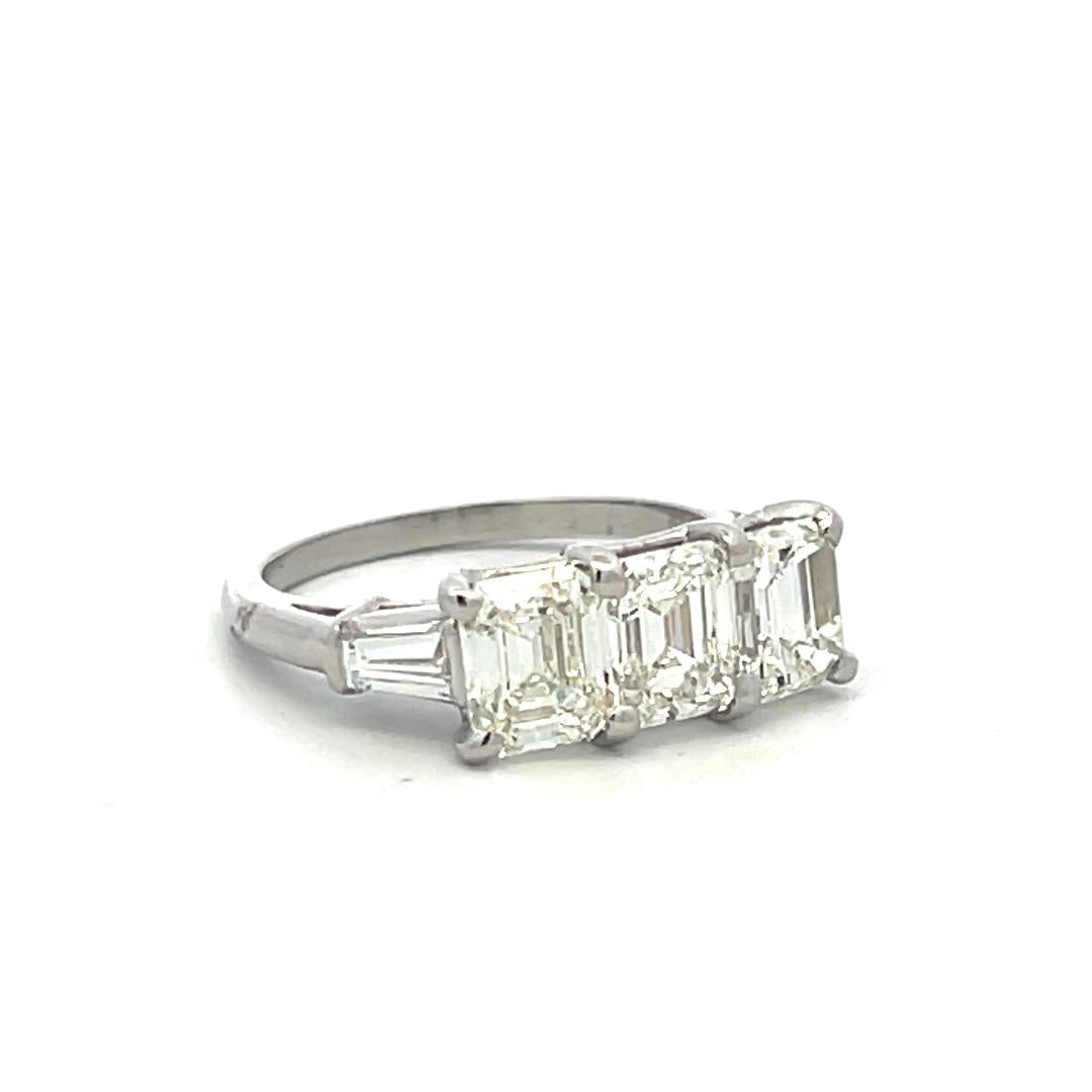 Vintage White Platinum Three-Stone Ring with 2.91 Carat Emerald Cut Diamonds GIA