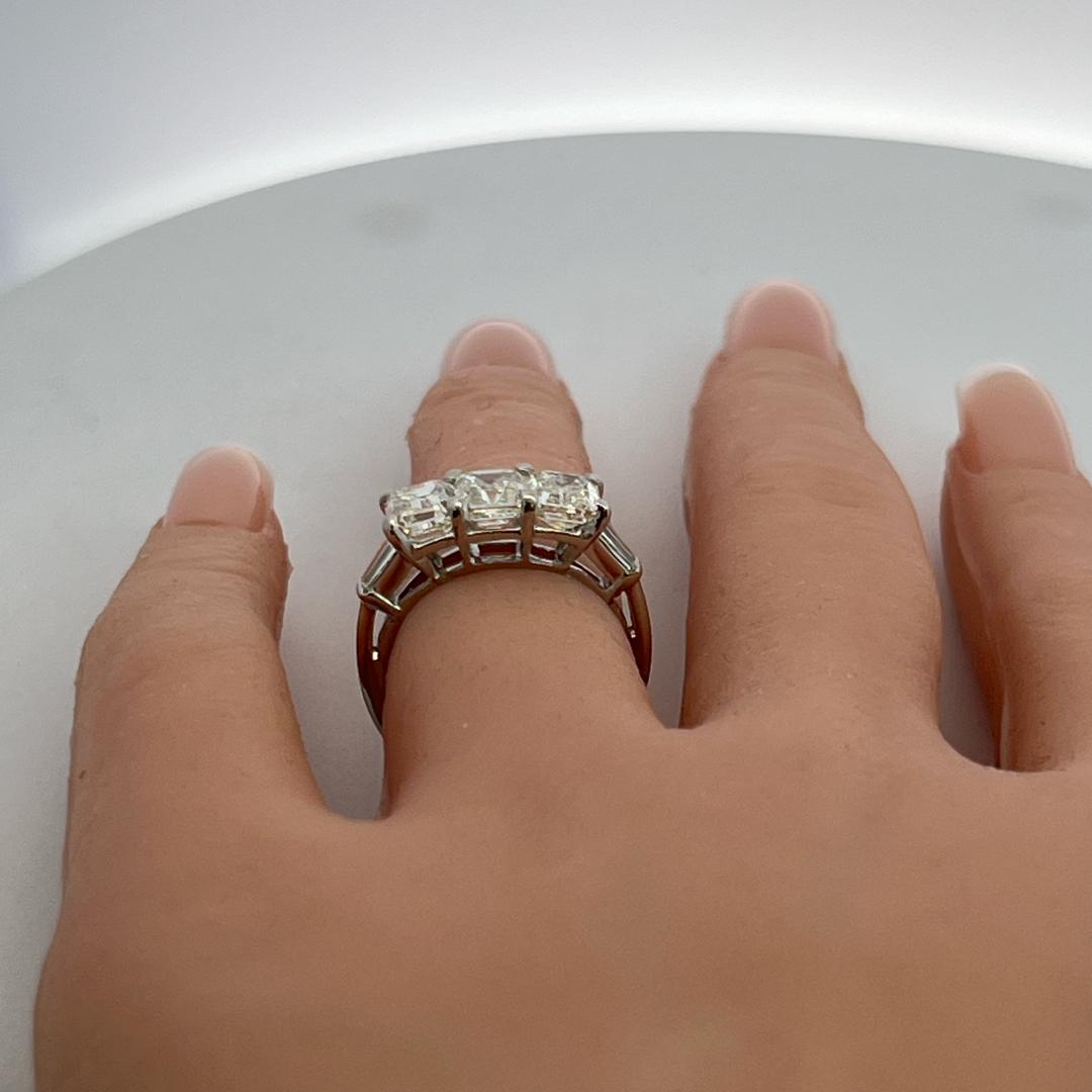 Vintage White Platinum Three-Stone Ring with 2.91 Carat Emerald Cut Diamonds GIA