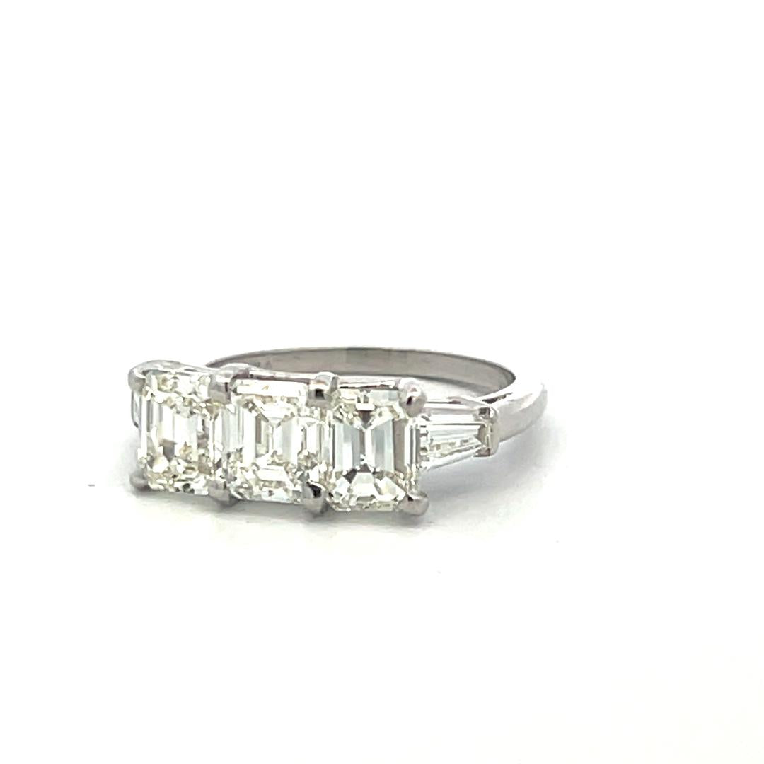 Vintage White Platinum Three-Stone Ring with 2.91 Carat Emerald Cut Diamonds GIA
