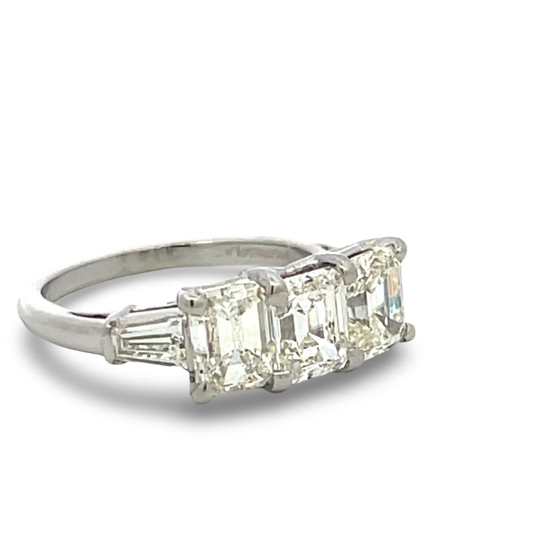 Vintage White Platinum Three-Stone Ring with 2.91 Carat Emerald Cut Diamonds GIA