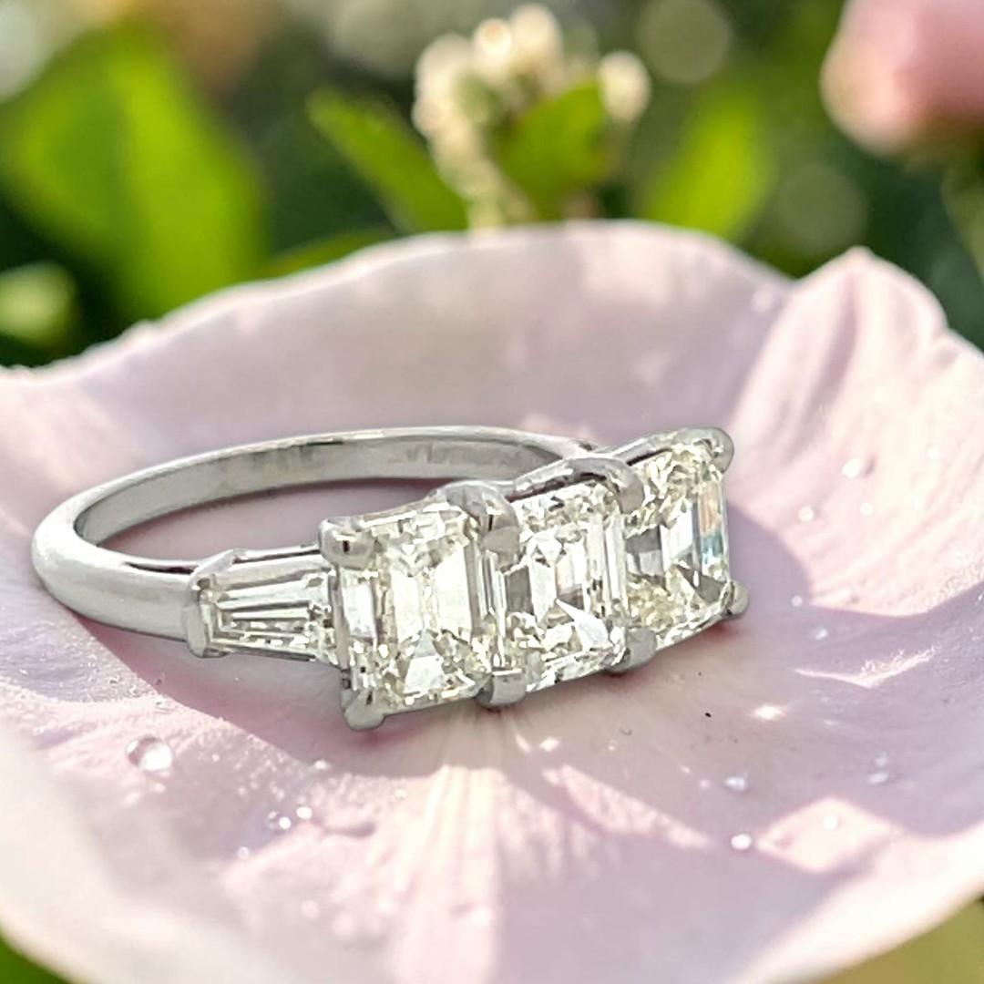 Vintage White Platinum Three-Stone Ring with 2.91 Carat Emerald Cut Diamonds GIA