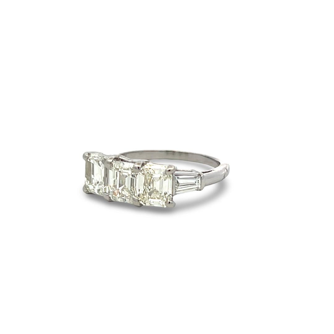 Vintage White Platinum Three-Stone Ring with 2.91 Carat Emerald Cut Diamonds GIA