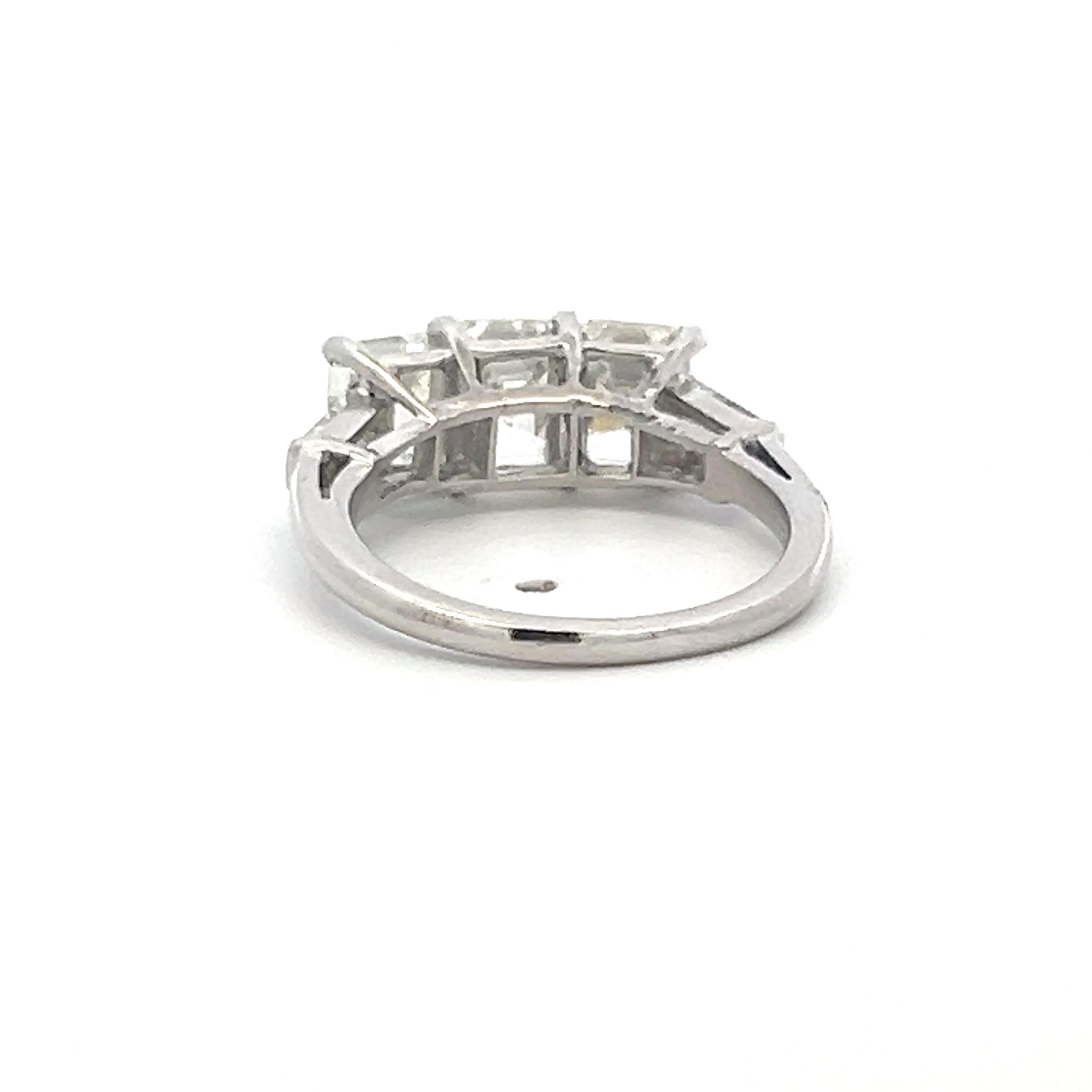 Vintage White Platinum Three-Stone Ring with 2.91 Carat Emerald Cut Diamonds GIA