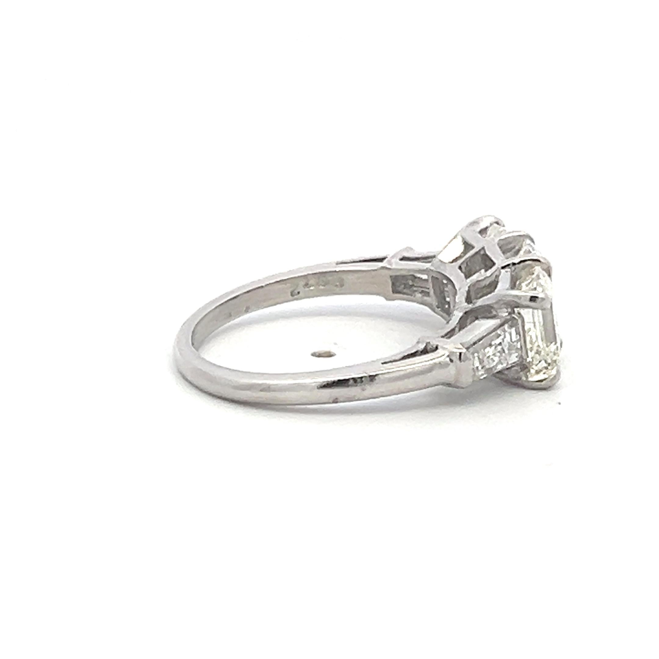 Vintage White Platinum Three-Stone Ring with 2.91 Carat Emerald Cut Diamonds GIA
