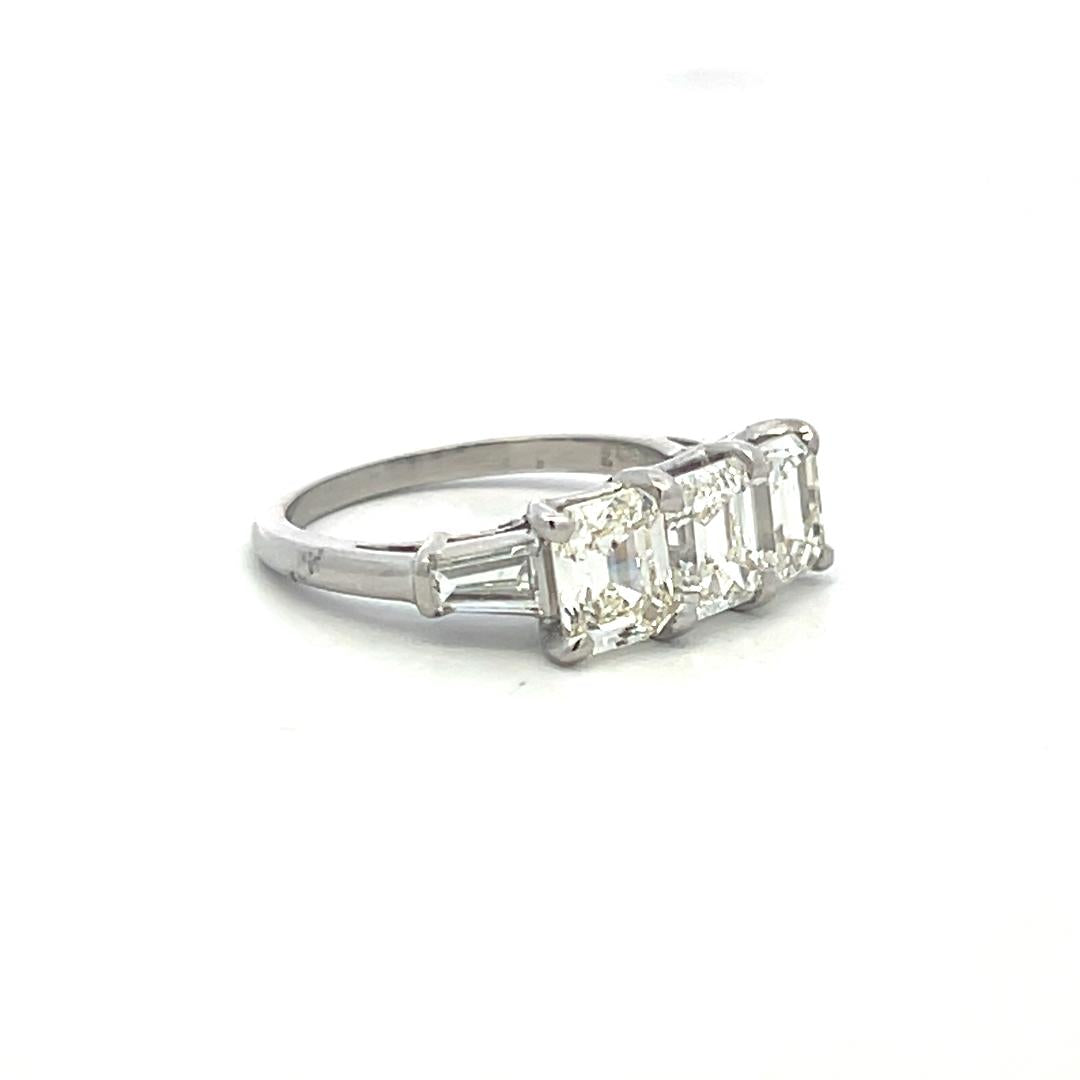 Vintage White Platinum Three-Stone Ring with 2.91 Carat Emerald Cut Diamonds GIA