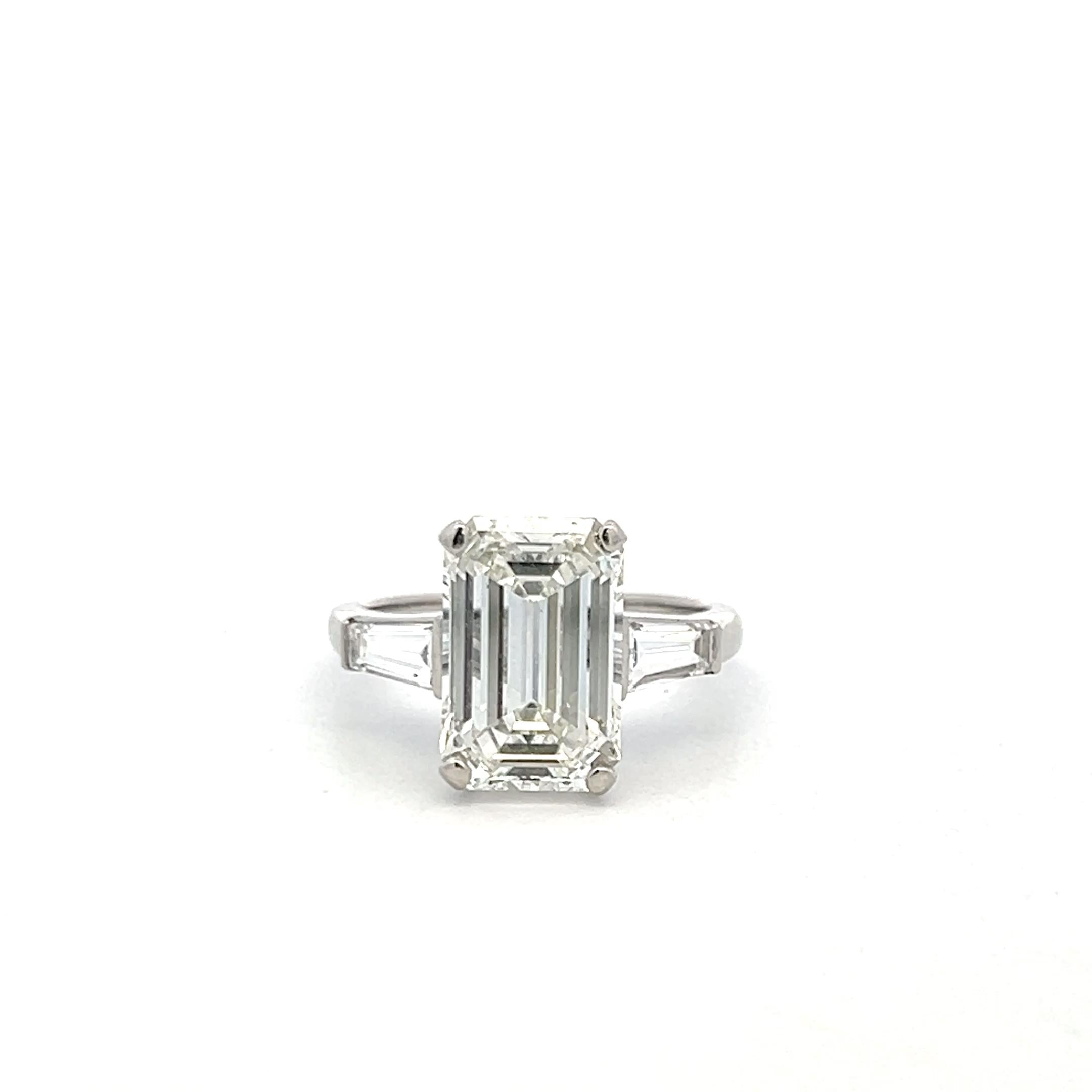 Vintage Platinum Engagement Ring with 4.89 Carat GIA Emerald cut Diamonds H VS1
